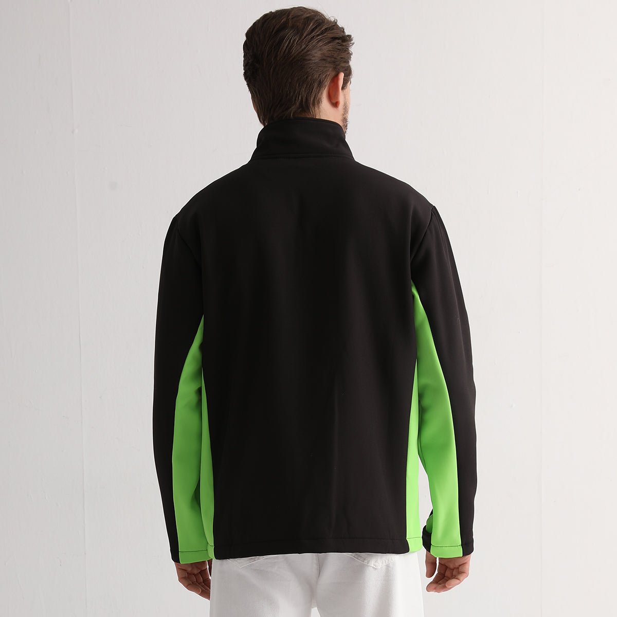 panel softshell jacket in Black with green lime, model back – Big Bee Workwear