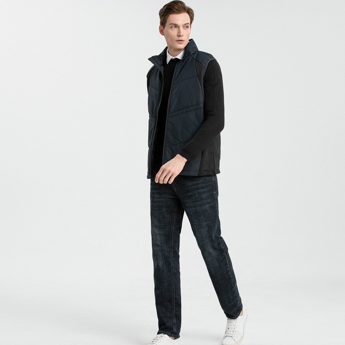 "elite puffer vest in black, model walking pose – ISUSI"