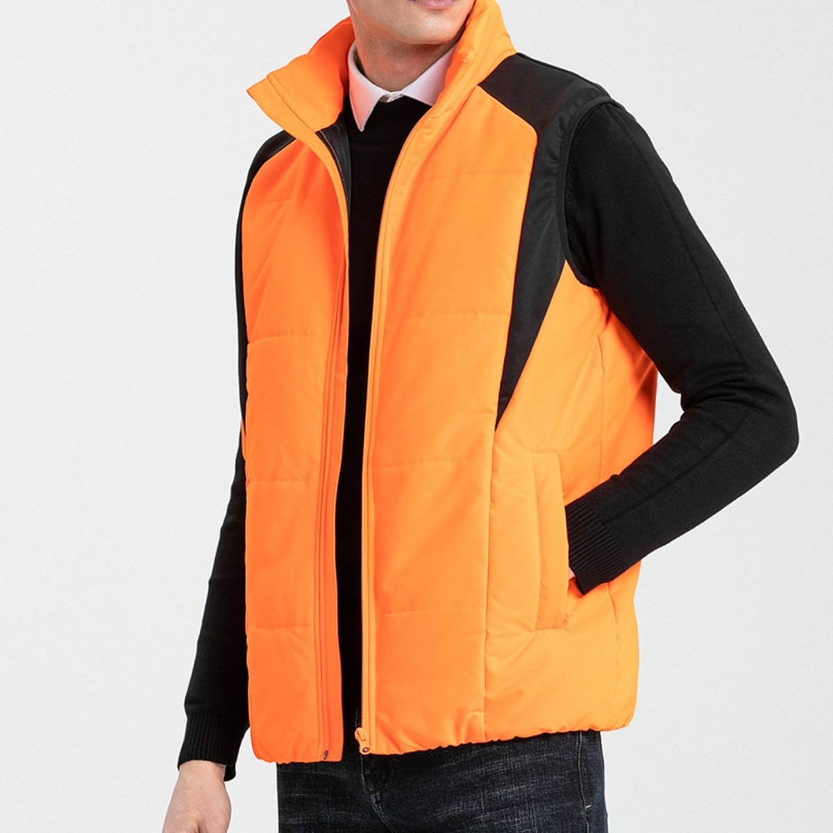"strike puffer vest in orange, model side – ISUSI"