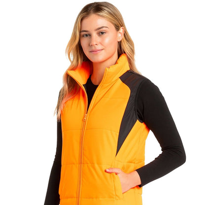 "ladies strike puffer vest in orange, model side – ISUSI"